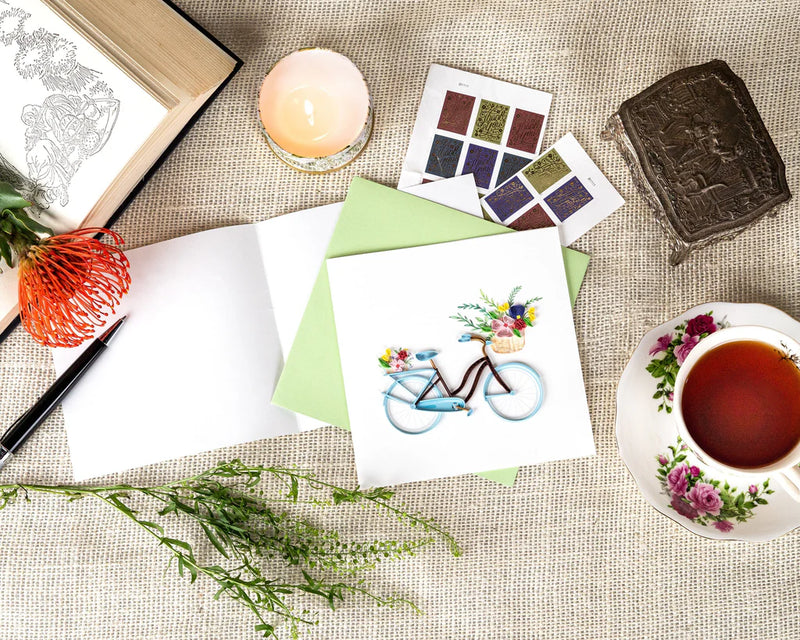 Hand-quilled greeting card featuring a blue bicycle with a flower-filled basket and green border, perfect for cheerful occasions.