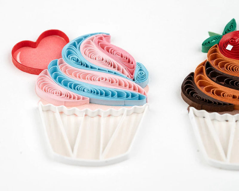 Quilled birthday card with three cupcakes topped in colorful frosting, candy decor, and gold “Happy Birthday” script—fun and festive.