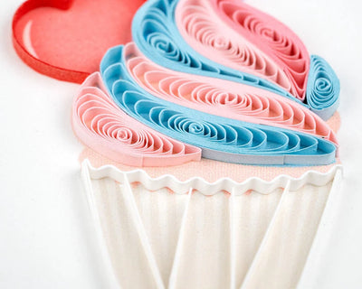 Quilled birthday card with three cupcakes topped in colorful frosting, candy decor, and gold “Happy Birthday” script—fun and festive.