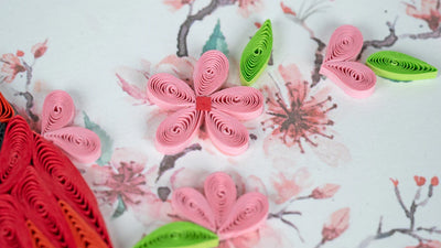 Quilled greeting card featuring a red cardinal perched among delicate pink cherry blossoms on a soft pastel background.