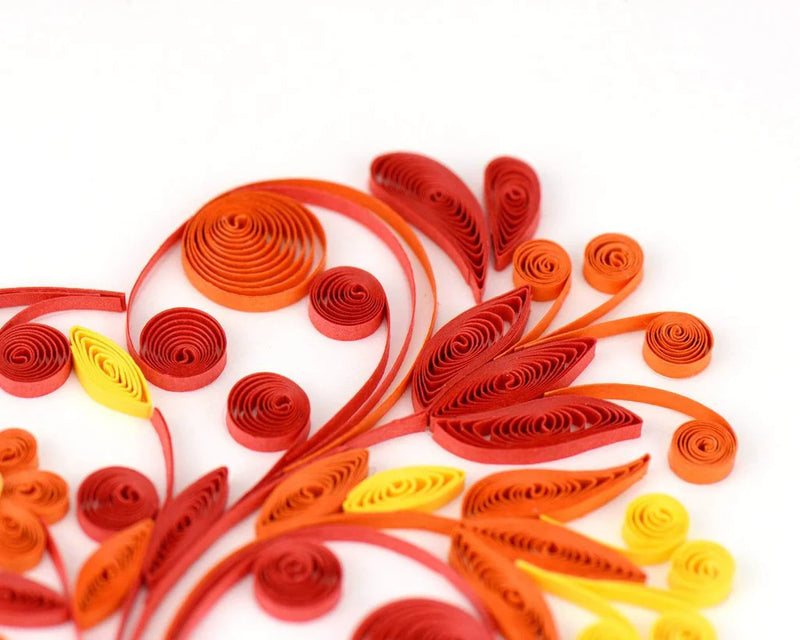 Quilled greeting card featuring a large heart made of red, pink, and gold swirls and floral patterns. Romantic handmade art card.