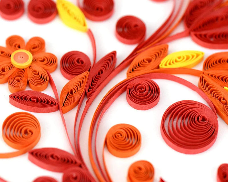 Quilled greeting card featuring a large heart made of red, pink, and gold swirls and floral patterns. Romantic handmade art card.