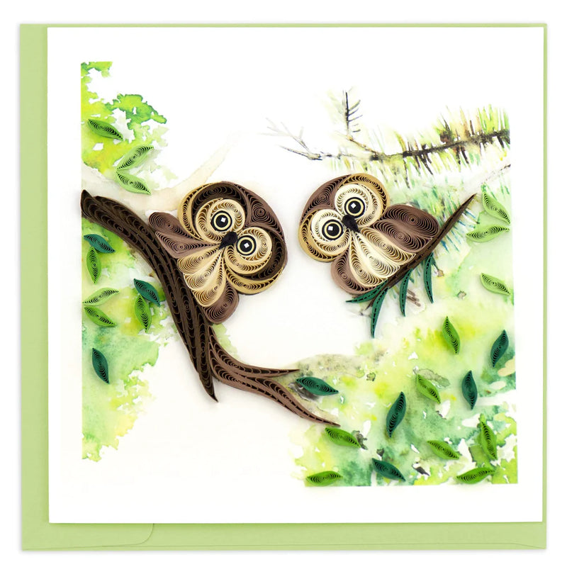 Quilled card with two brown owlets perched on leafy green branches, symbolizing wisdom, protection, and sweet friendship.
