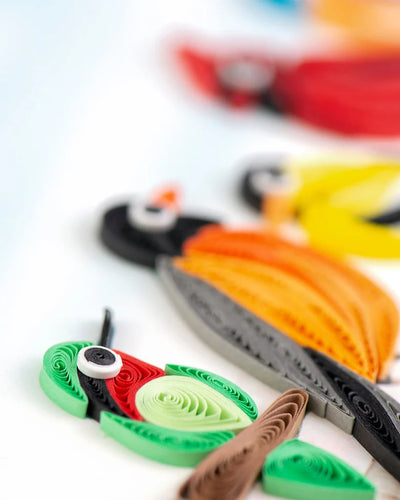 Quilled card with five colorful birds, including a cardinal and hummingbird, perched on a branch—symbolizing joy, unity, and nature's song.