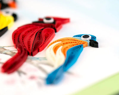 Quilled card with five colorful birds, including a cardinal and hummingbird, perched on a branch—symbolizing joy, unity, and nature's song.