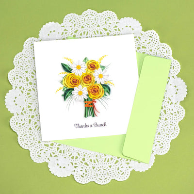 Handcrafted card with quilled yellow and white flower bouquet and “Thanks a Bunch” message. Light green envelope included.