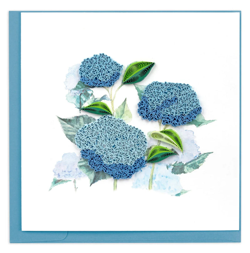 Quilled card showcasing a cluster of vibrant blue hydrangeas with green leaves, delicately handcrafted on a soft white background.