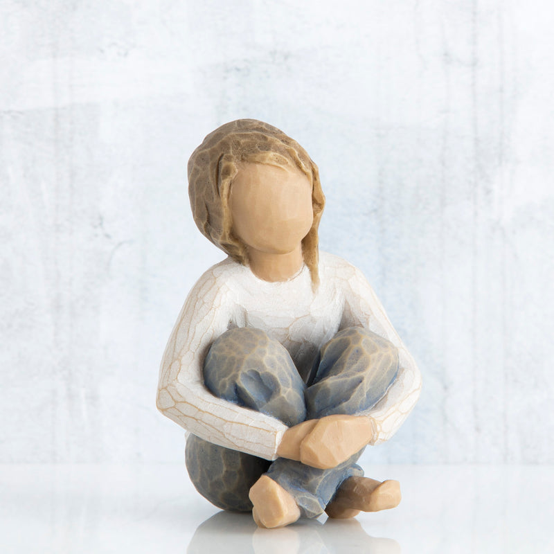 Willow Tree Spirited Child figurine of seated girl with arms wrapped around knees.