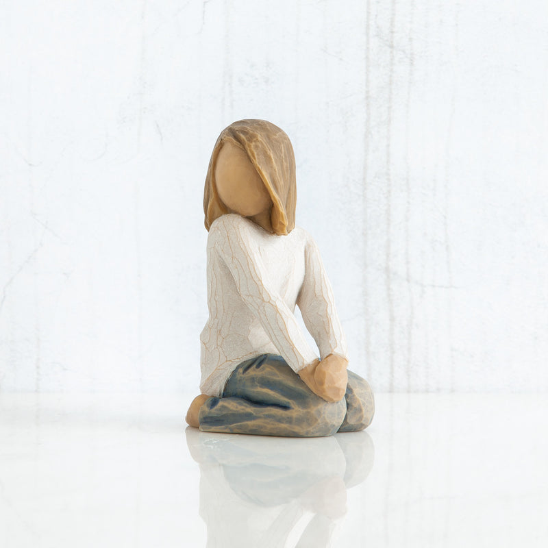 Willow Tree Joyful Child figurine of kneeling girl with arms folded on knees.