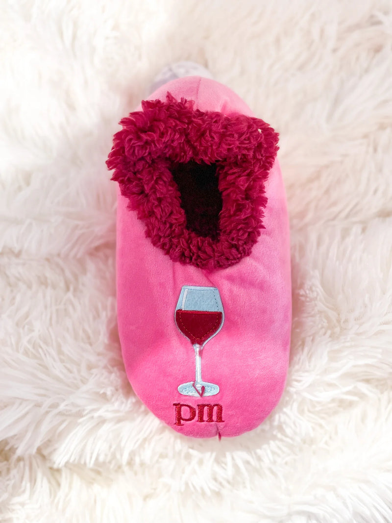 Pink cozy sherpa slippers with AM coffee and PM wine design, non-skid soles by Snoozies.