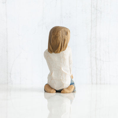 Willow Tree Joyful Child figurine of kneeling girl with arms folded on knees.