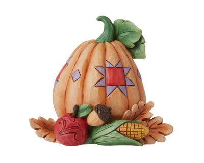 Jim Shore "Pumpkin with Bounty Mini" figurine from Heartwood Creek, featuring a small pumpkin.