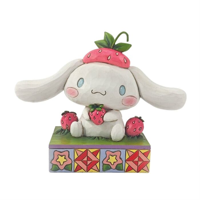 Jim Shore Cinnamoroll figurine sitting in grass with strawberries, hand-painted in folk art style bright Sanrio