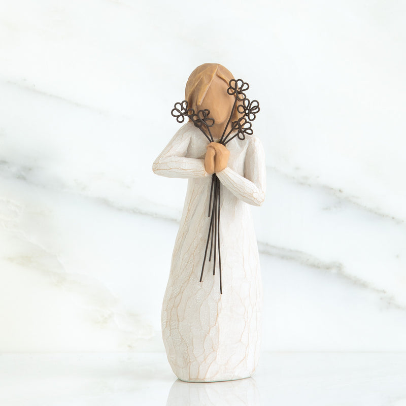 Willow Tree Friendship figurine holding five wire flowers in cream dress.
