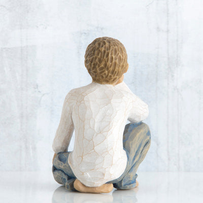 Willow Tree Inquisitive Child figurine kneeling with hand under chin.