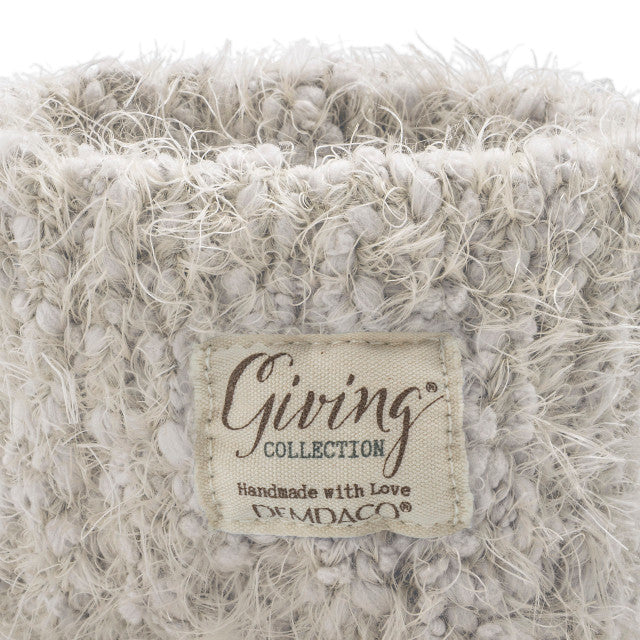 Cream fuzzy women’s socks with rubber grippers on the soles, ultra-soft and cozy, part of the Demdaco Giving Collection.