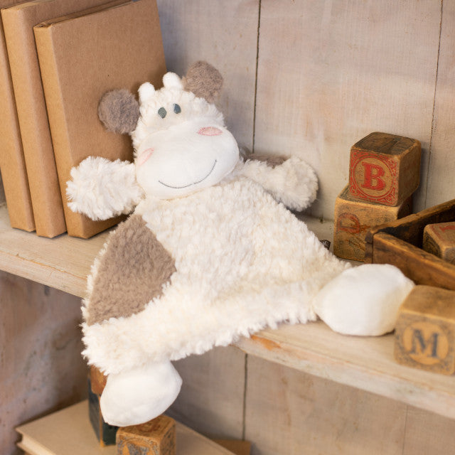 White and black plush cow rattle blankie with soft fabric, stitched face, floppy limbs, and 13-inch comforting design.