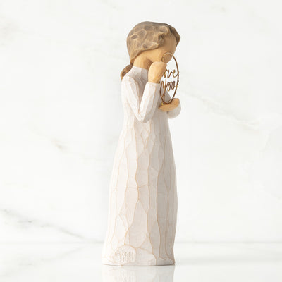 Willow Tree Love You figurine holding gold wire circle with message.