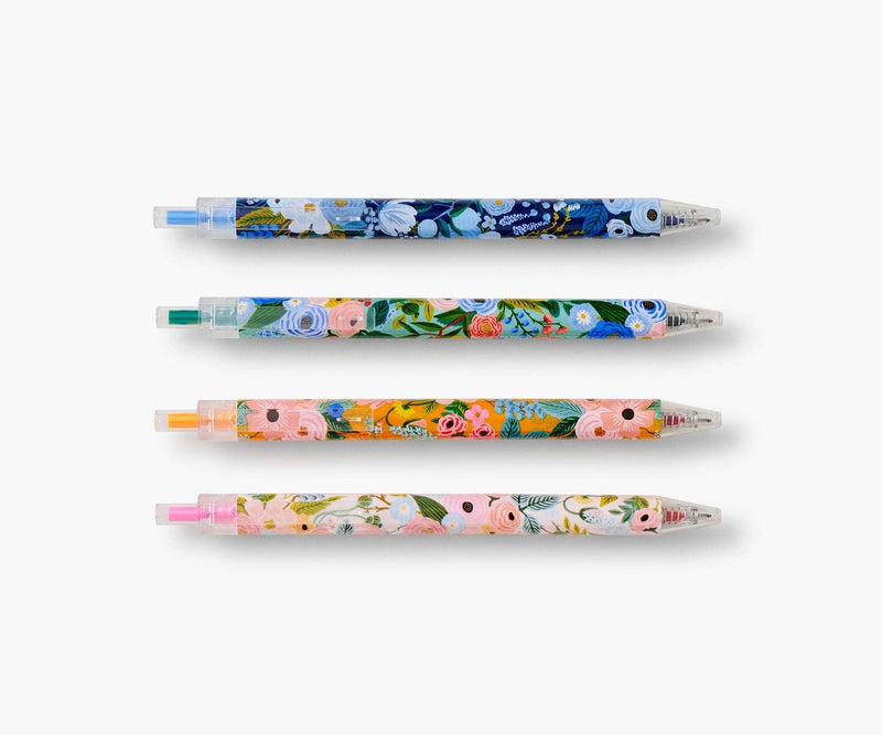 Set of four Rifle Paper Co. Garden Party gel pens with floral patterns and bright ink colors in pink, orange, green, and blue.