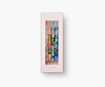 Set of four Rifle Paper Co. Garden Party gel pens with floral patterns and bright ink colors in pink, orange, green, and blue.