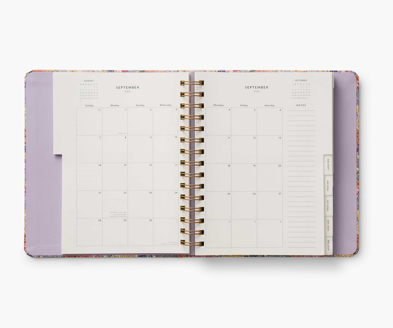 Rifle Paper Co. Mimi 2024–2025 planner with floral cover, gold foil accents, weekly and monthly views, stickers, and storage folders.