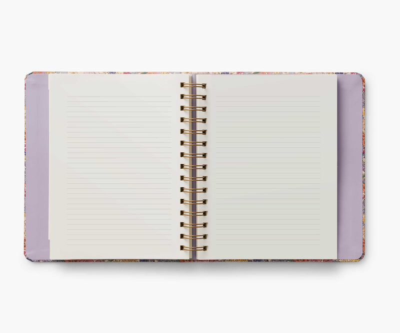 Rifle Paper Co. Mimi 2024–2025 planner with floral cover, gold foil accents, weekly and monthly views, stickers, and storage folders.