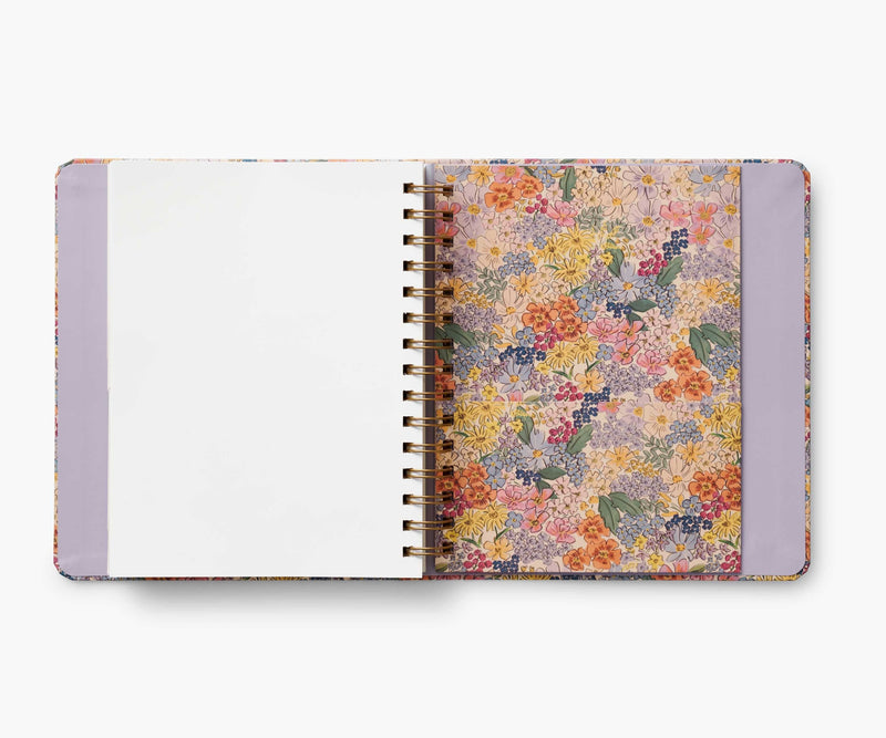 Rifle Paper Co. Mimi 2024–2025 planner with floral cover, gold foil accents, weekly and monthly views, stickers, and storage folders.