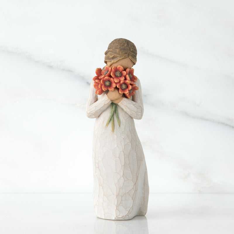 Willow Tree Surrounded by Love figurine holding red-orange poppy bouquet.