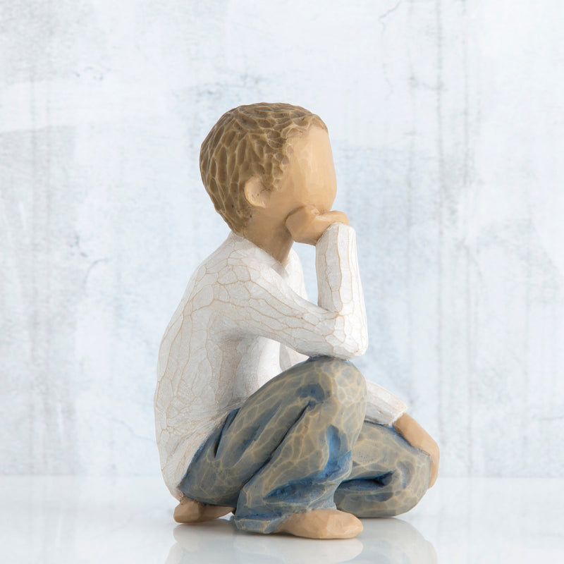 Willow Tree Inquisitive Child figurine kneeling with hand under chin.