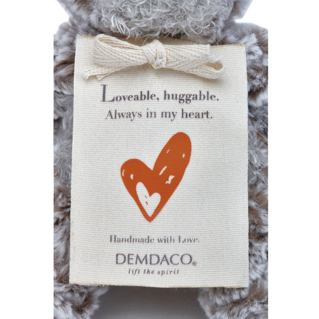 Small beige plush bear with a heart-shaped patch and a "Love" message, soft fabric, 8.5 inches tall, perfect for gifting.

