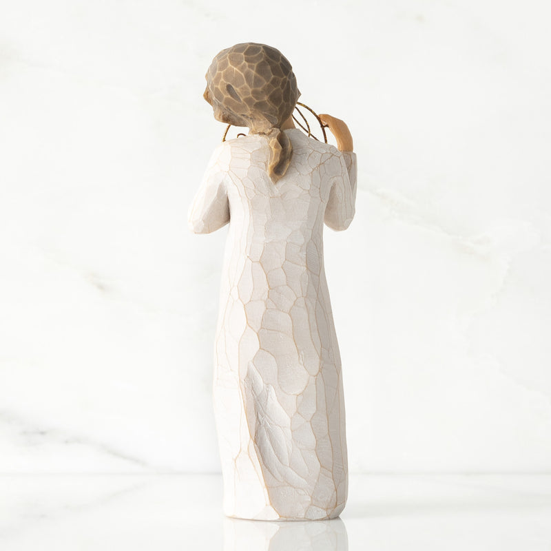 Willow Tree Love You figurine holding gold wire circle with message.