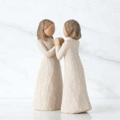 Willow Tree Sisters by Heart figurines, two women in cream dresses with interlocking hands facing each other.