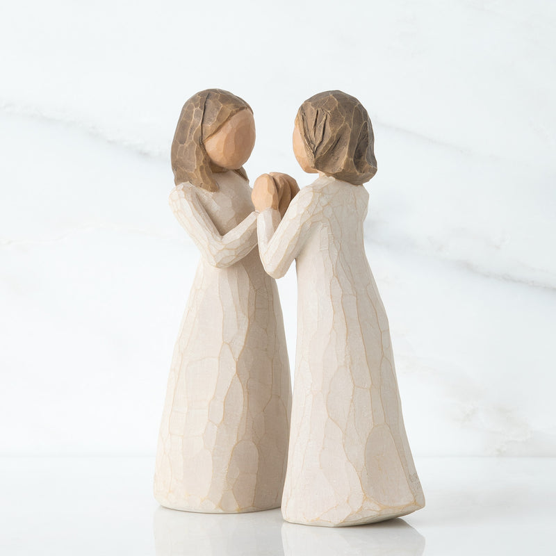 Willow Tree Sisters by Heart figurines, two women in cream dresses with interlocking hands facing each other.