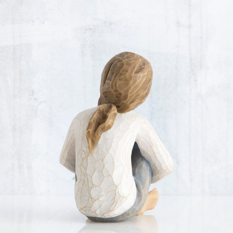 Willow Tree Spirited Child figurine of seated girl with arms wrapped around knees.