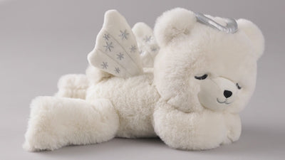 Hallmark angel bear plush toy with silver halo and embroidered wings plays instrumental 'Amazing Grace' lullaby at the press 
