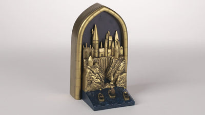 Hallmark Harry Potter light-up Hogwarts bookshelf decoration with starry night background and dimensional castle design.

