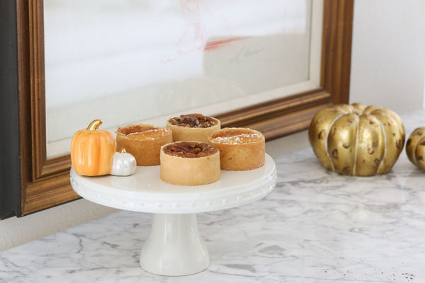 A ceramic mini pumpkin with warm pumpkin spice colors, perfect for fall and seasonal décor.

