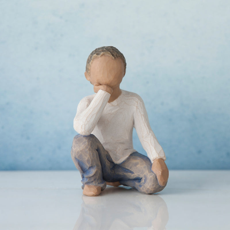 Willow Tree Inquisitive Child figurine of kneeling boy with darker skin tone and hair.