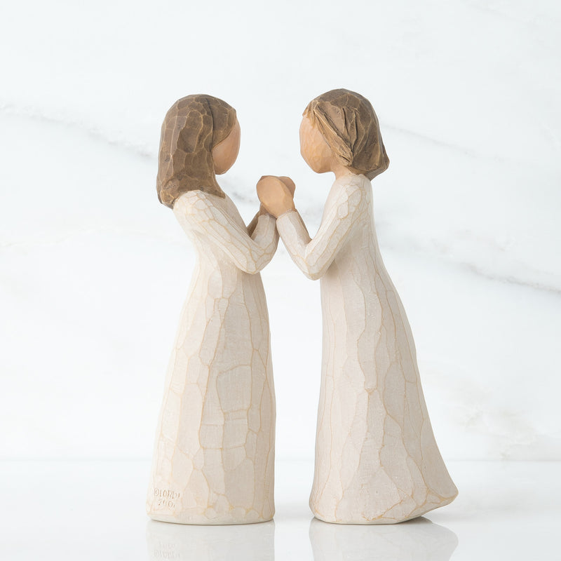 Willow Tree Sisters by Heart figurines, two women in cream dresses with interlocking hands facing each other.