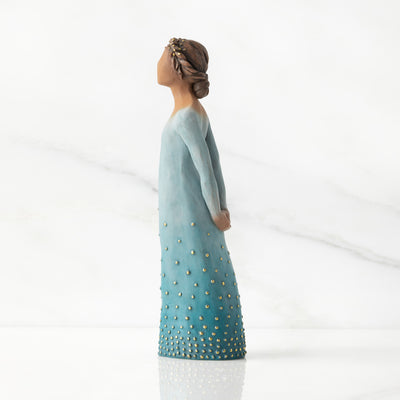 Willow Tree Radiance figurine with darker skin in a deep blue ombré dress dotted with gold leaf.