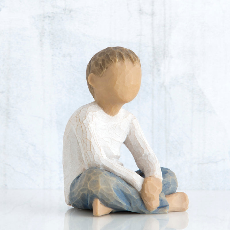 Willow Tree Imaginative Child figurine seated cross-legged with arms folded in lap.