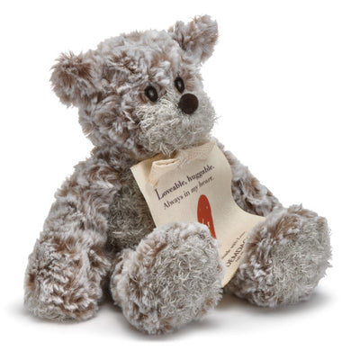 Small beige plush bear with a heart-shaped patch and a "Love" message, soft fabric, 8.5 inches tall, perfect for gifting.

