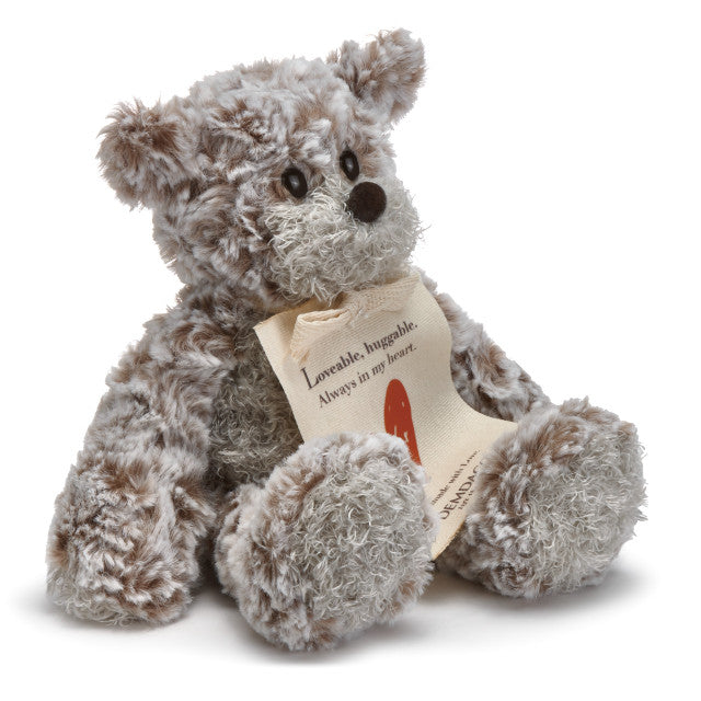 Small beige plush bear with a heart-shaped patch and a "Love" message, soft fabric, 8.5 inches tall, perfect for gifting.

