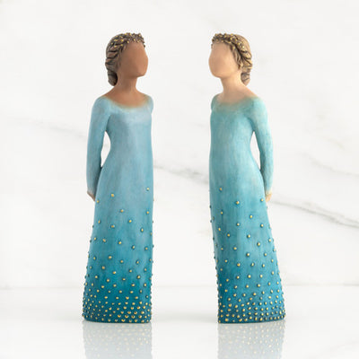 Willow Tree Radiance figurine with darker skin in a deep blue ombré dress dotted with gold leaf.