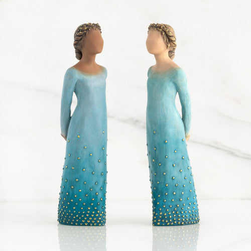 Willow Tree Radiance figurine with darker skin in a deep blue ombré dress dotted with gold leaf.
