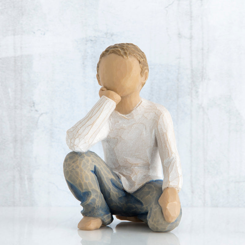 Willow Tree Inquisitive Child figurine kneeling with hand under chin.
