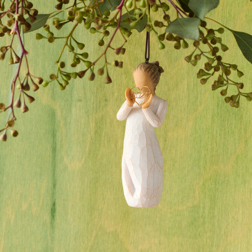Willow Tree 2025 Ornament figurine in cream dress holding a golden wire heart with 2025 inside, hanging by a brown cord.