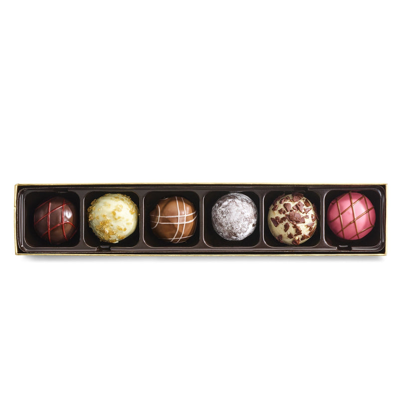 Satisfy their sweet tooth with our innovative chocolate truffles, artfully crafted in flavors inspired by the world&