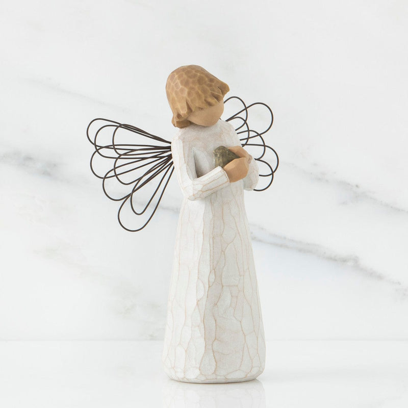 Angel of Healing: Willow Tree with a Standing Angel in a cream dress and wire wings, holding a blue-gray bird in her hands.