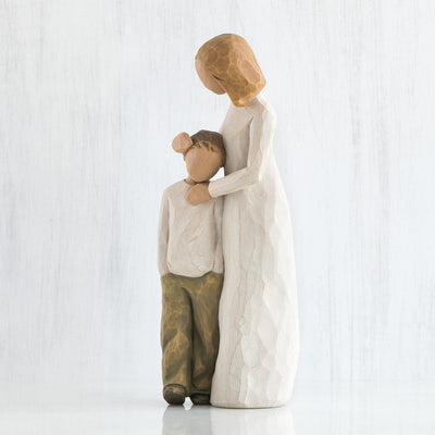 Mother and Son, Willow Tree, with standing figure in cream dress, with arms around young boy in cream shirt and dark pants.